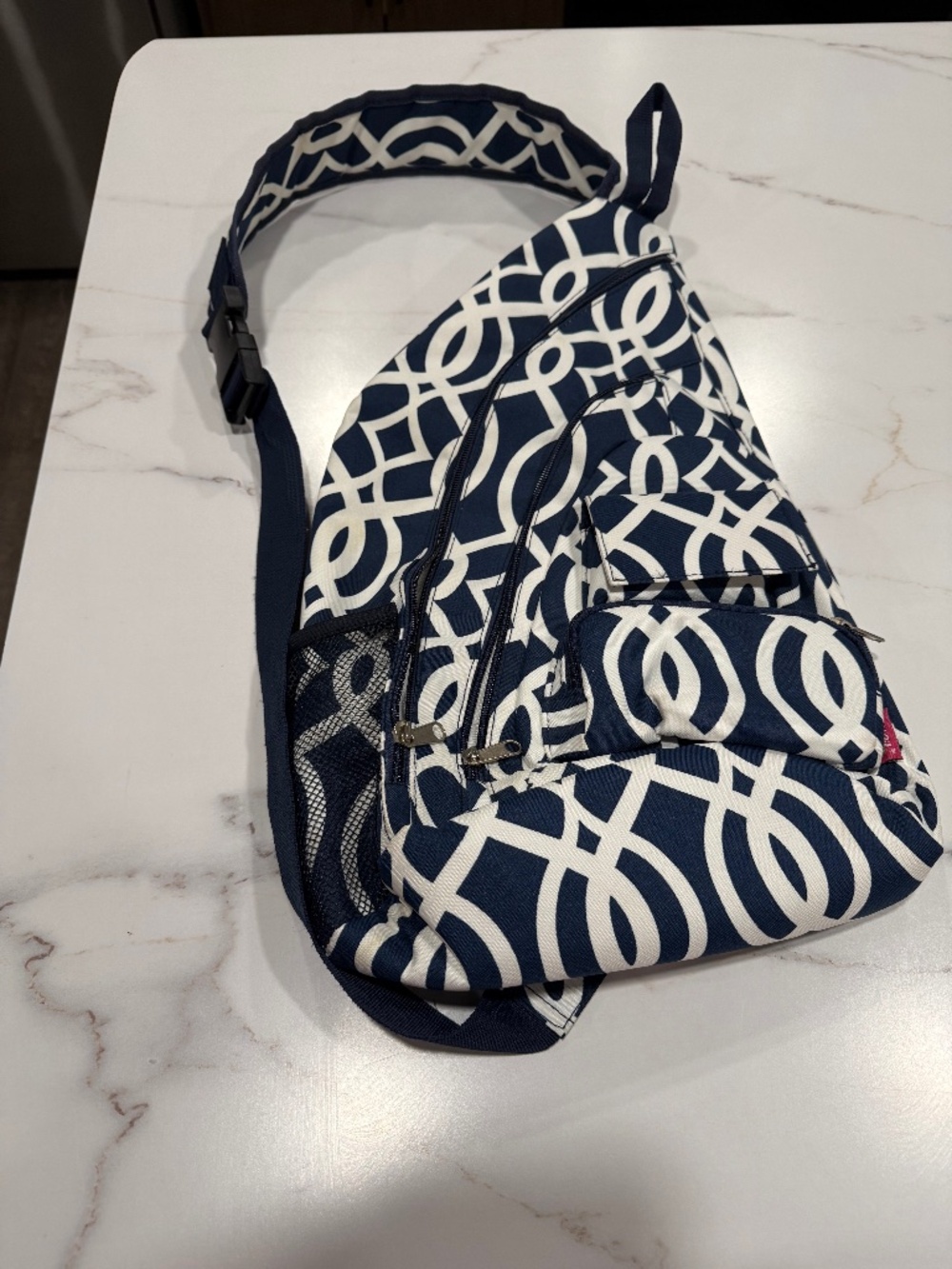N.Gil rope Crossbody sling bag in a navy and white trellis geometric pattern
